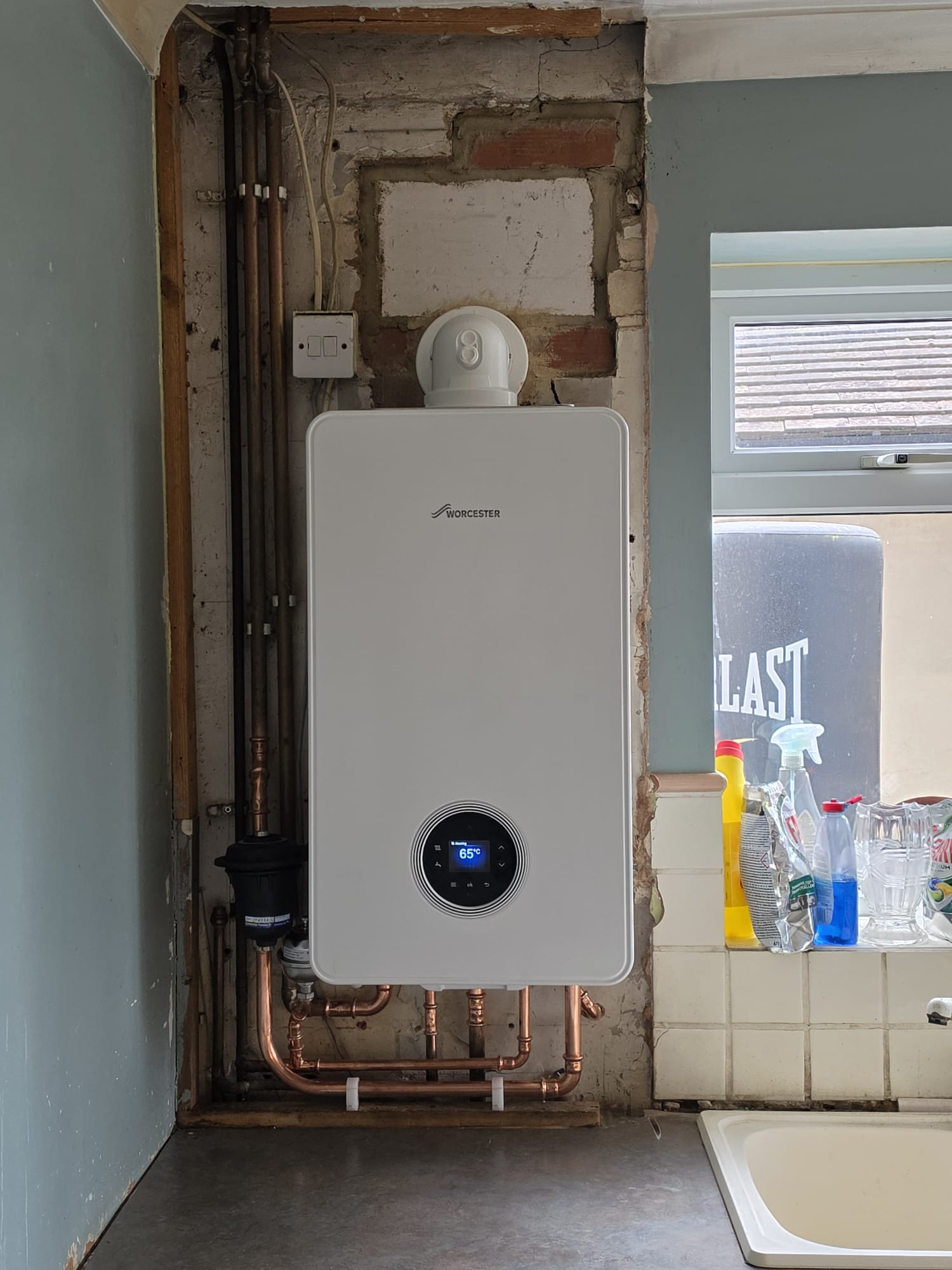 Worcester Bosch combi boiler installation with Filterquick magnetic filter and neat copper pipework in a Surrey kitchen
