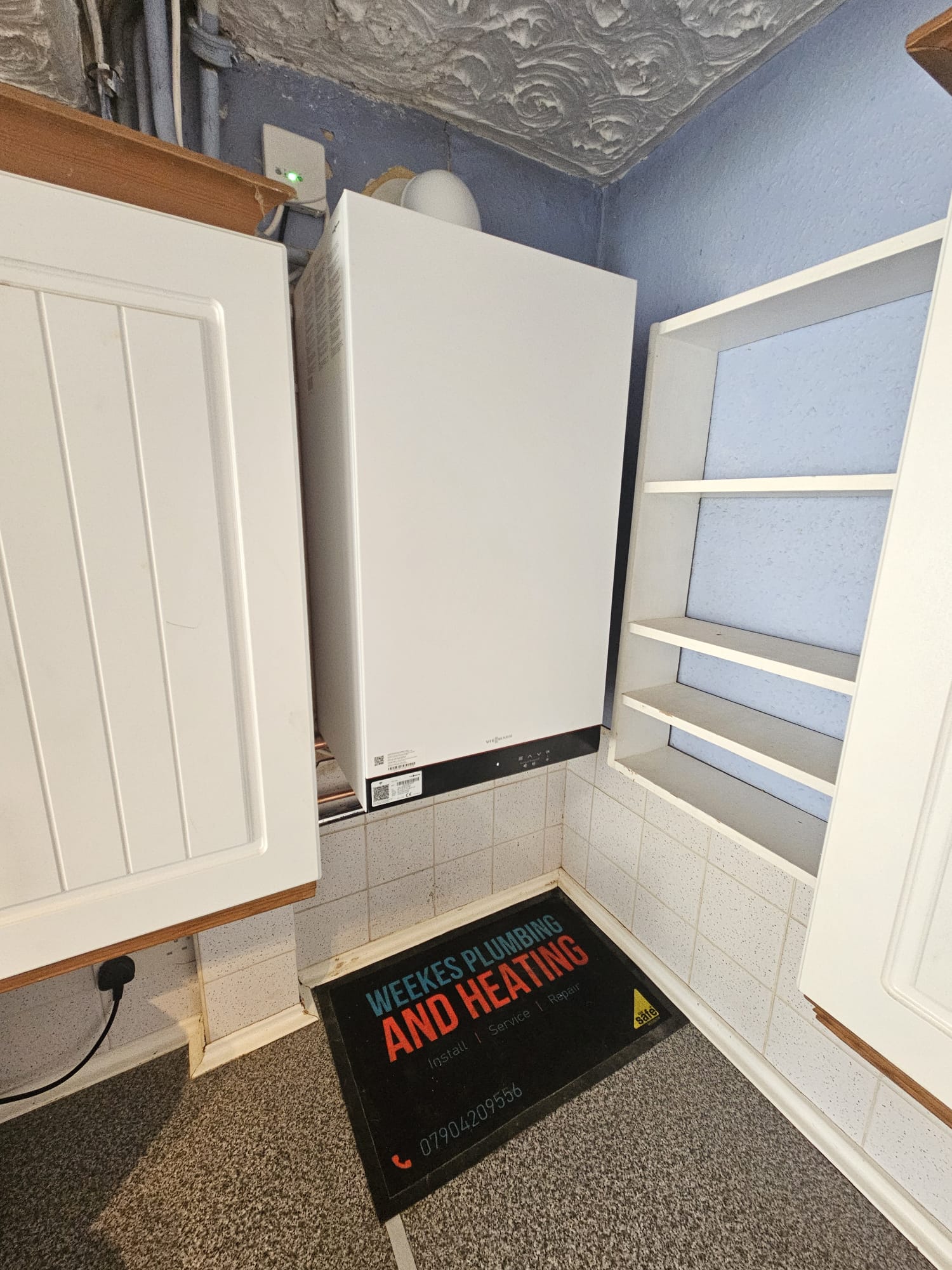 Viessmann combi boiler installation with Weekes Plumbing & Heating branded floor mat